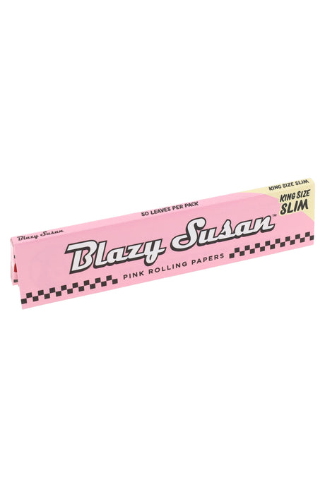 Single booklet of Blazy Susan King Size Slim pink rolling papers, 50 leaves per pack, pastel wrapper with checker trim and logo.