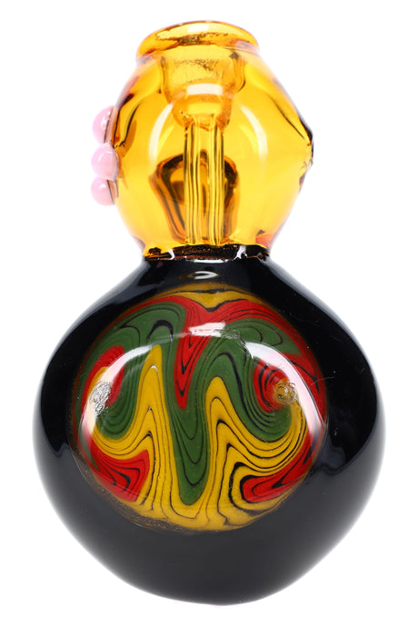 Close-up of reverse rasta swirl disk on black hammer bubbler with amber bowl and side marbles; colors vary; 7-inch size.