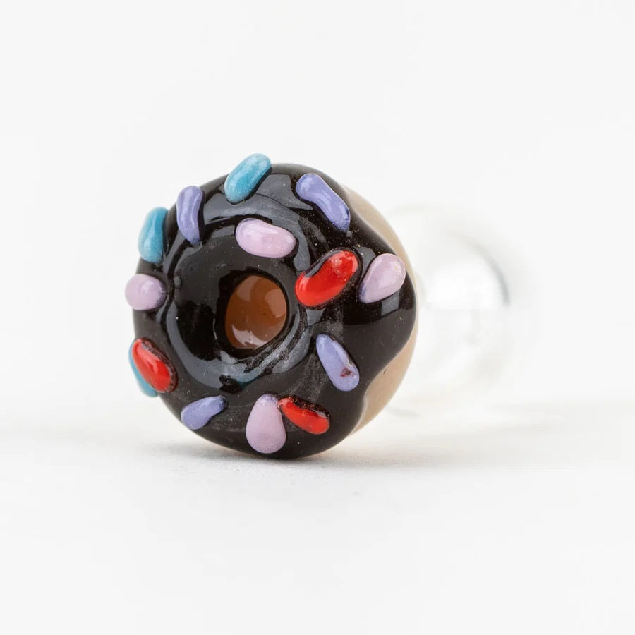 Bottom view of donut cap highlighting the raised sprinkle details and center opening, attached to a smooth clear glass section.