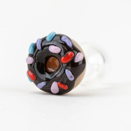 Bottom view of donut cap highlighting the raised sprinkle details and center opening, attached to a smooth clear glass section.
