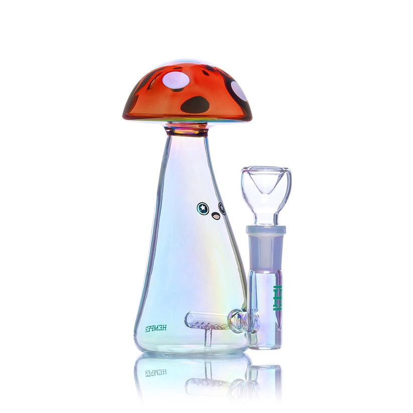 Angled studio shot of Hemper Trippy Shroom 6-inch iridescent glass bong with inline perc, red spotted mushroom cap and included 14mm flower bowl.