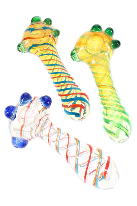 5-inch color-changing glass spoon with spiral striping and three green grip marbles on the bowl, shown in assorted colorways.