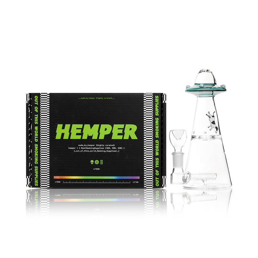 Teal Hemper UFO Vortex glass bong standing beside black “out of this world smoking supplies” Hemper box, shelf-ready display setup.