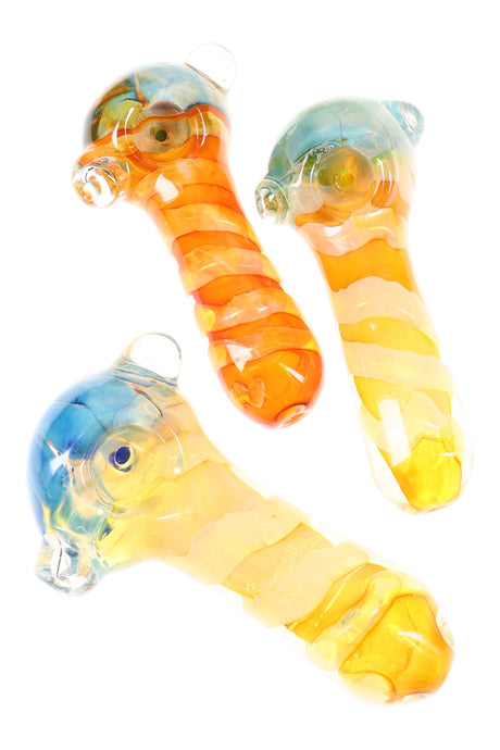 4½″ gold-fumed glass spoon pipe with spiral stripes, deep bubble bowl, and side marble roll-stop in assorted warm color tones.