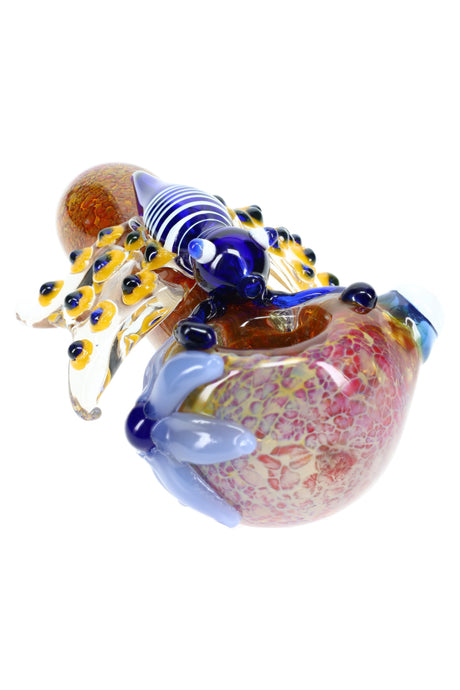 Close-up of butterfly-applique glass spoon bowl with frit and color-changing silver fume detailing.