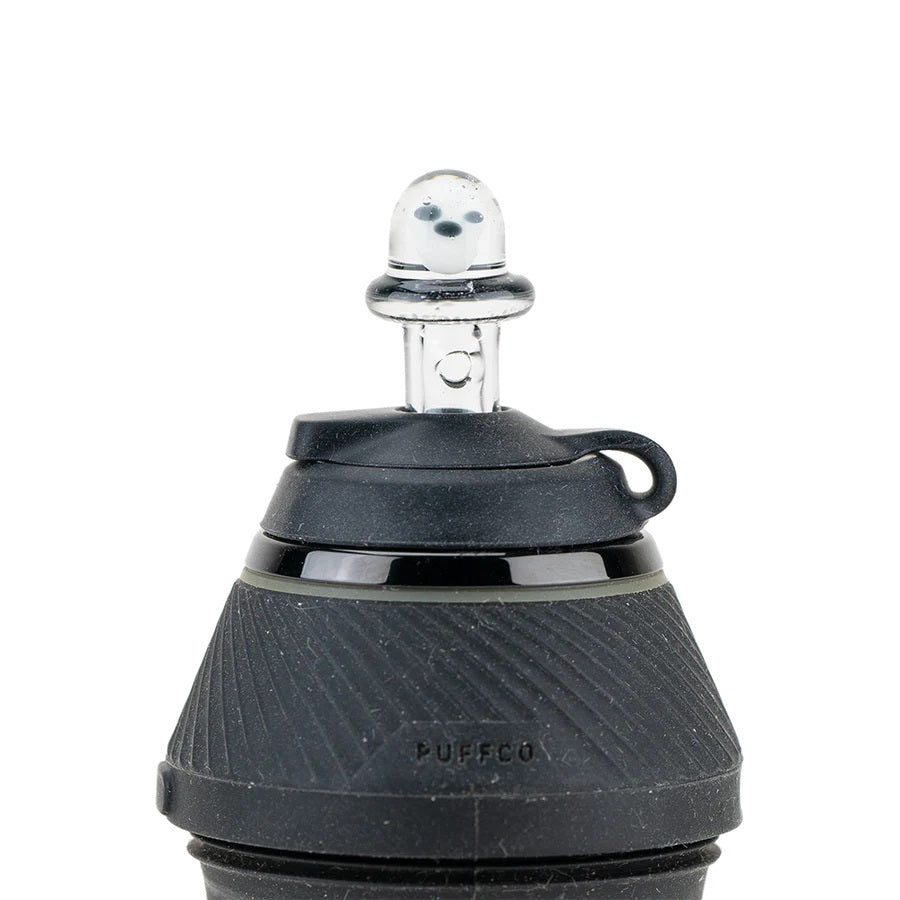 Daylight view of the Martian cap mounted on a Puffco Peak Pro, clear dome with alien detail facing forward.