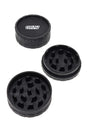 Black GRAV 2.5″ hemp-plastic 2-piece herb grinder with sharp teeth, shown open and closed on a clean white background.