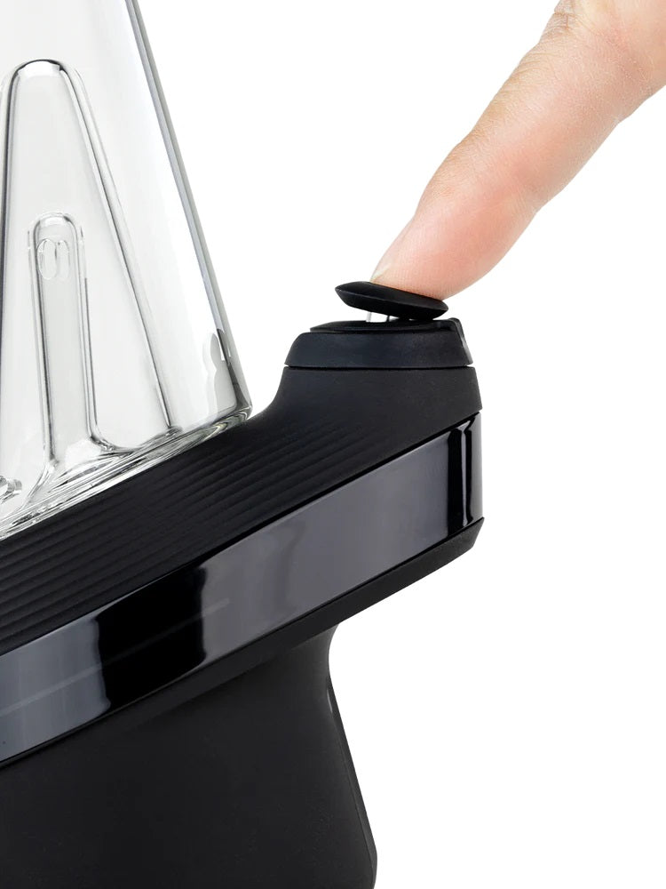 Close-up of New Peak’s top button being pressed to cycle heat presets on the electric dab rig.