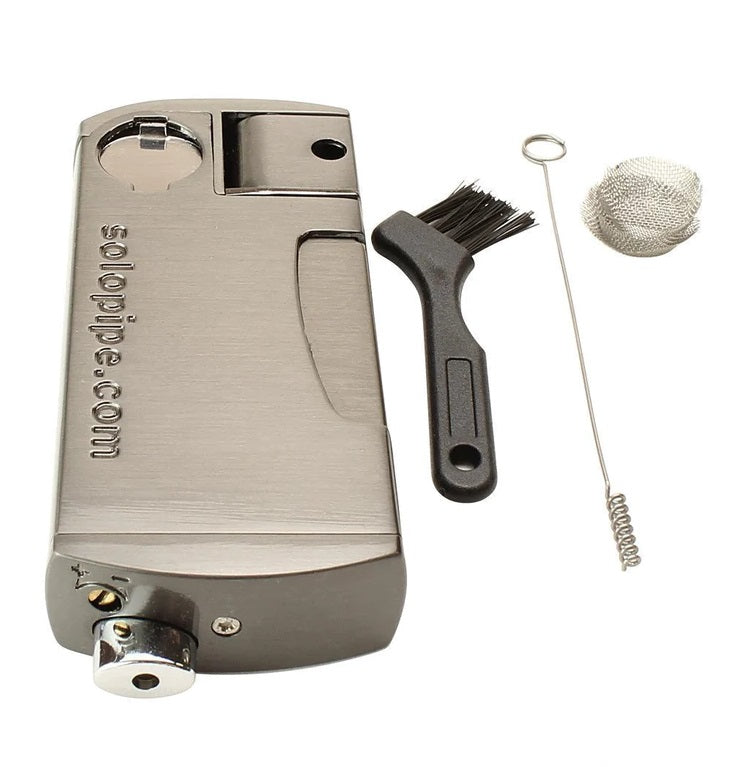 Gunmetal Solopipe kit with cleaning brush, poker, and round metal screens, showing lighter refill port and bowl area.