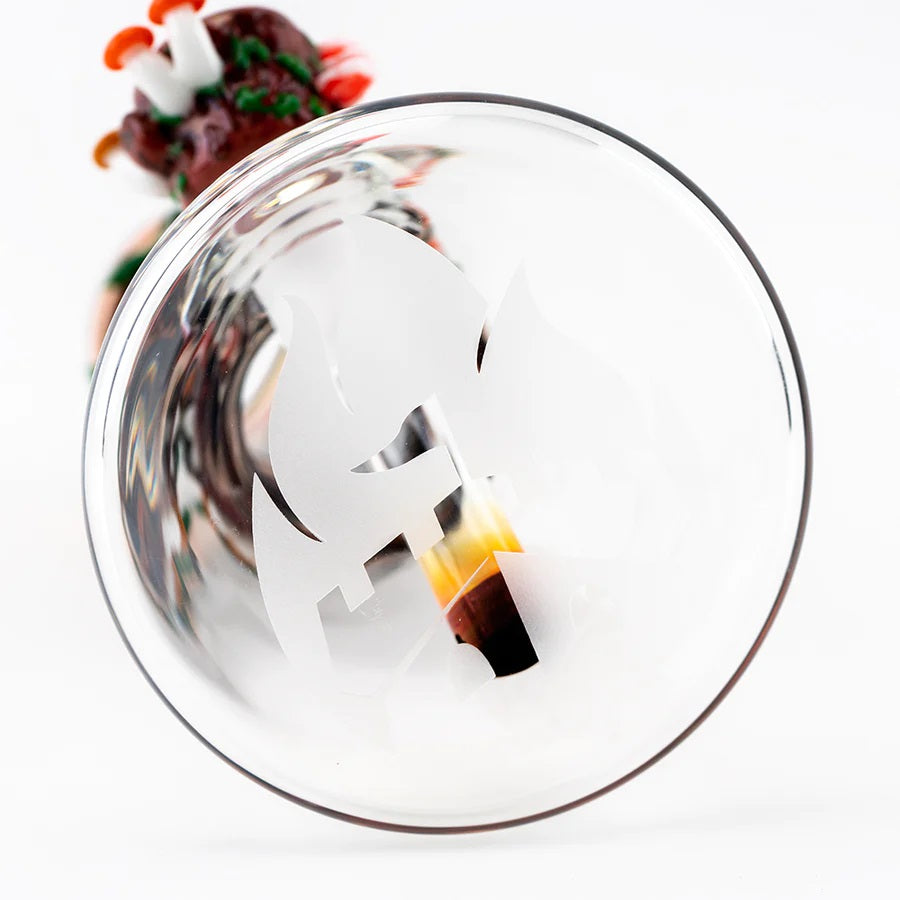 Frosted logo etched on the underside of a clear baby beaker base from a redwood-themed water pipe.