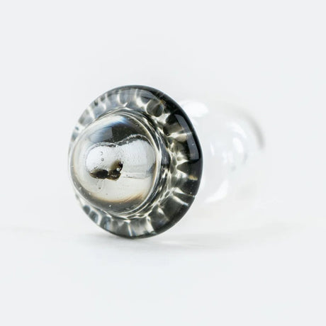 Bottom view of the dome showing the tiny alien detail and smooth saucer edge on the glass Peak Pro cap.
