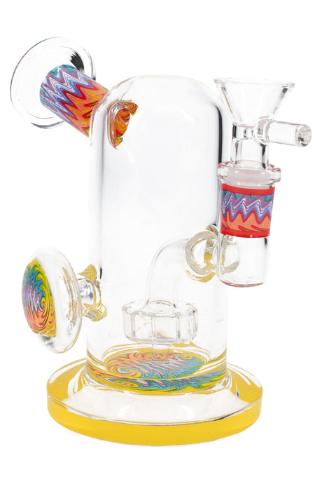 Clear 5″ mini bong with yellow base, reverse swirl accents, showerhead perc, and 14.5 mm female joint.