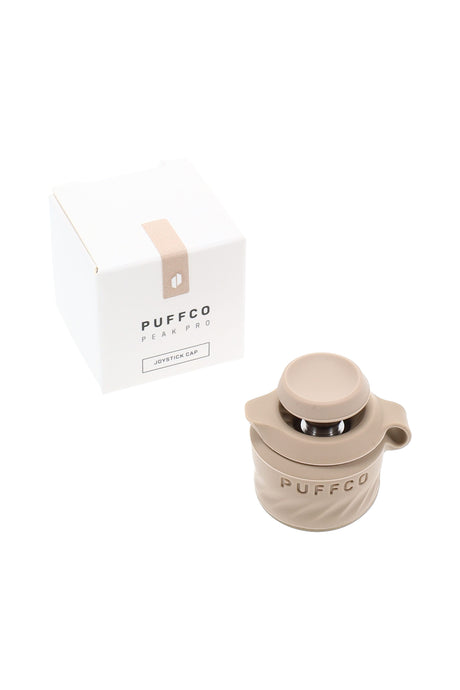 Tan Puffco Peak Pro Joystick Cap shown with retail packaging, directional Peak Pro accessory that steers airflow for smooth, even vapor.