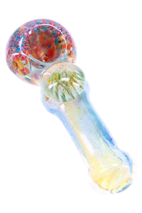 Close-up of silver-fumed spoon handle with magnifying floral marble and speckled frit bowl.