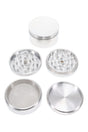 3¼″ 4-part metal herb grinder disassembled to show diamond teeth, magnetic lid, mesh pollen screen, and kief catch base.