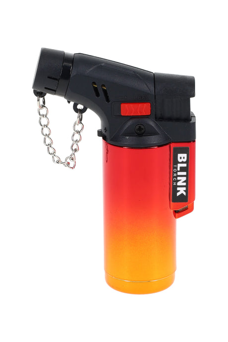 Blink mini metallic butane torch lighter in red–orange gradient with angled nozzle, safety lock, and chain, studio view.