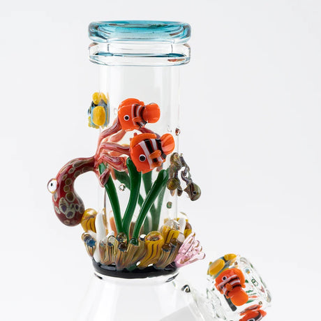 Close view of clownfish, anemones, and sea grass sculpted around the neck of a compact baby beaker bong.