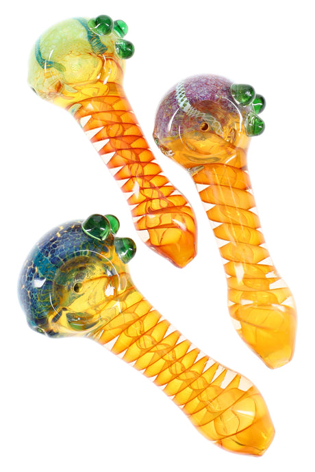4½-inch gold-fumed color-changing glass spoon with spiral ribbon stem, frit bowl cap, and three green grip marbles, shown in assorted colors.