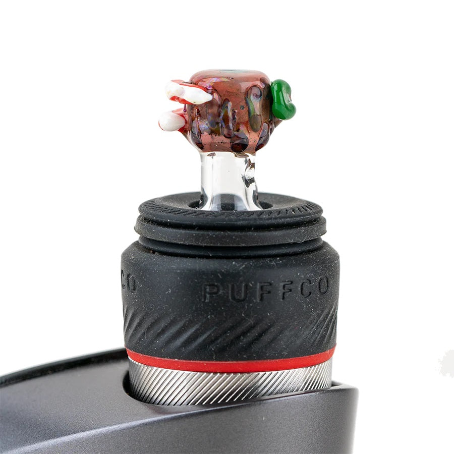 Hootie ball cap installed on a Puffco Peak Pro, standing upright in the rubber collar to show proper fit and scale.