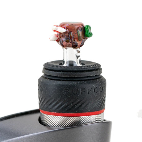 Hootie ball cap installed on a Puffco Peak Pro, standing upright in the rubber collar to show proper fit and scale.