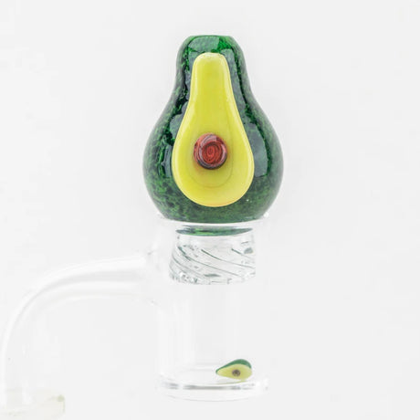 Avocado spinner cap seated on a flat-top quartz banger with matching mini avocado pearl spinning inside the bucket.