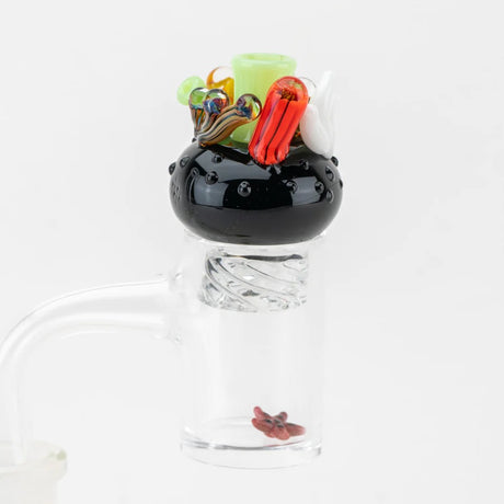 Cap seated on a quartz banger with the red starfish pearl inside the bucket, demonstrating real-world use.