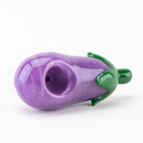 Angled close-up of eggplant bong bowl highlighting purple glass texture, green cap, and frosted male joint connection.