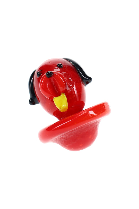 Close-up of red glass dog carb cap with black ears and yellow tongue, rounded base for sealing a quartz bucket.