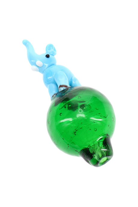 Light blue elephant bubble carb cap perched on green glass bubble base, designed to spin and guide airflow on a dab rig.
