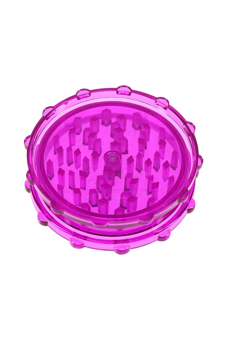 Magenta acrylic magnetic herb grinder, two-piece design with sturdy teeth and translucent body.