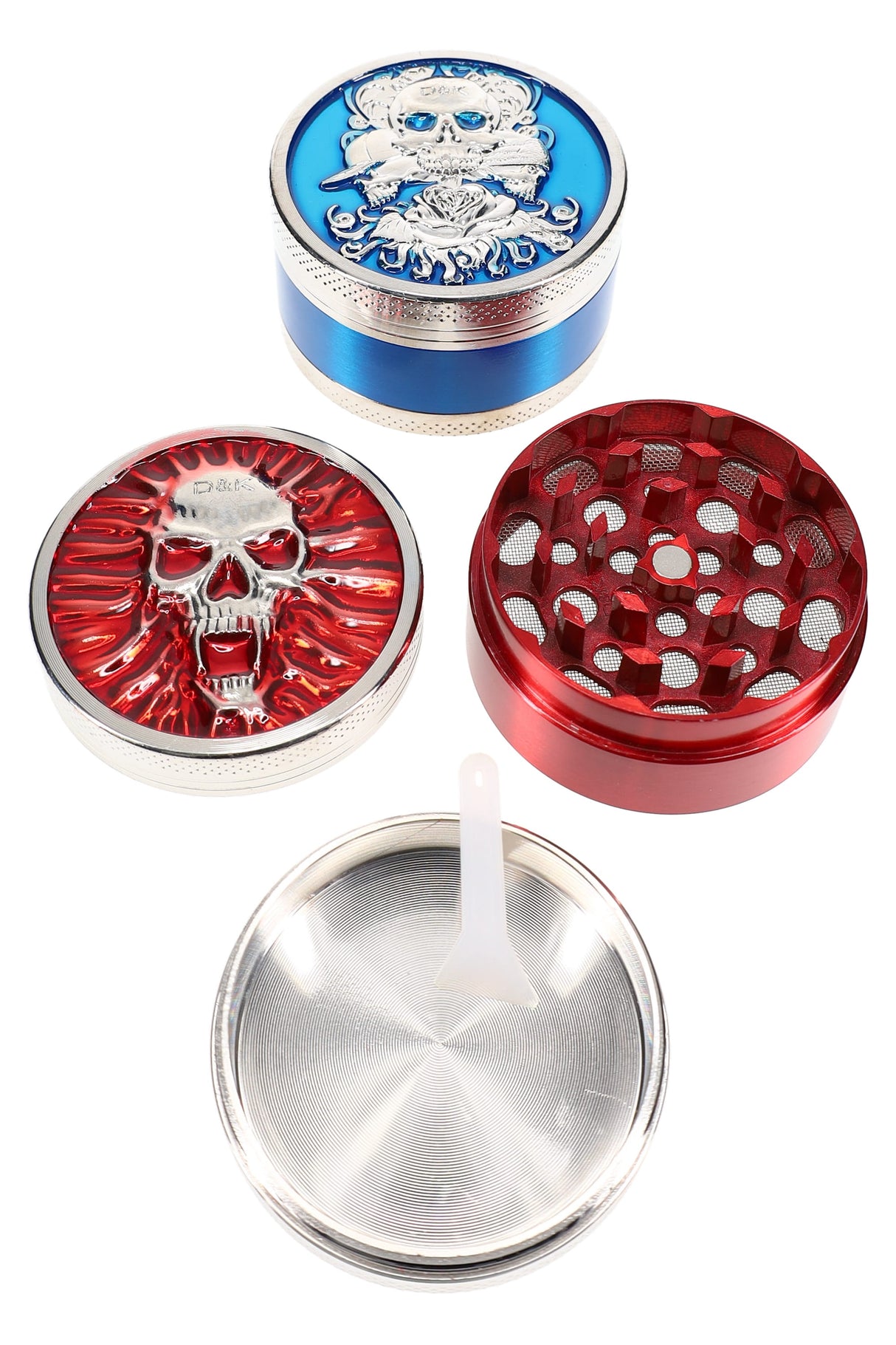 Colored 3-part metal herb grinder, 2″ size, skull-design lids in red and blue with mesh screen and kief scraper, pieces shown apart.