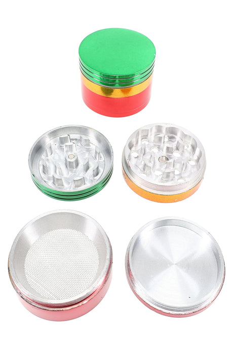 Rasta tri-color 4-part aluminum herb grinder with kief screen and catcher, shown disassembled; 1½″, 2″ or 2½″ sizes.