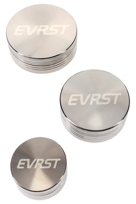 Gunmetal EVRST two-piece zinc-alloy herb grinder with low-profile design, top and bottom sections shown slightly separated on a white studio background.