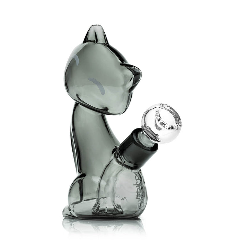 Compact smoky gray Hemper Alley Cats cat bong with rounded bowl joint and simple closed-eye face graphics, shown from side profile on white.