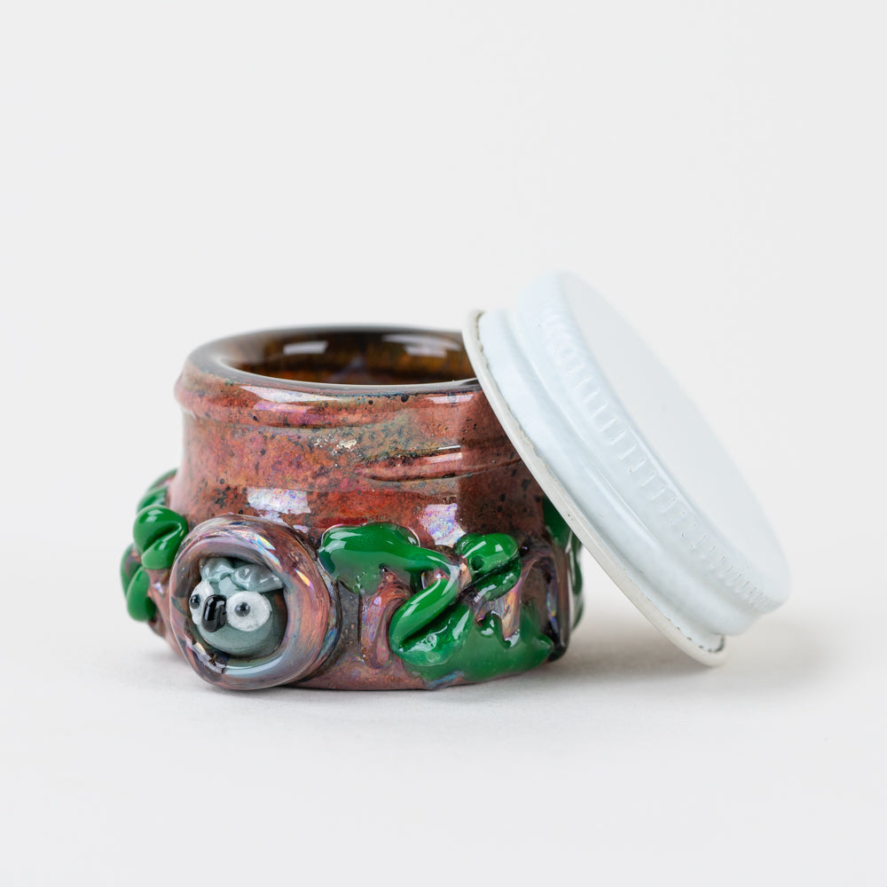 Open Empire Glassworks Hootie’s Forest terp jar showing white lid and amber glass interior