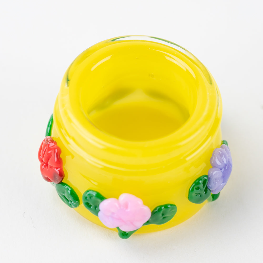 Empire Glassworks Sunshine Garden glass jar angled view with colorful flower accents and round body