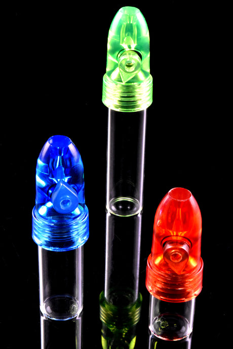 Trio of snuff bullet vials—red, green and blue caps—on clear 51 mm tubes, upright on reflective black backdrop, product close-up.