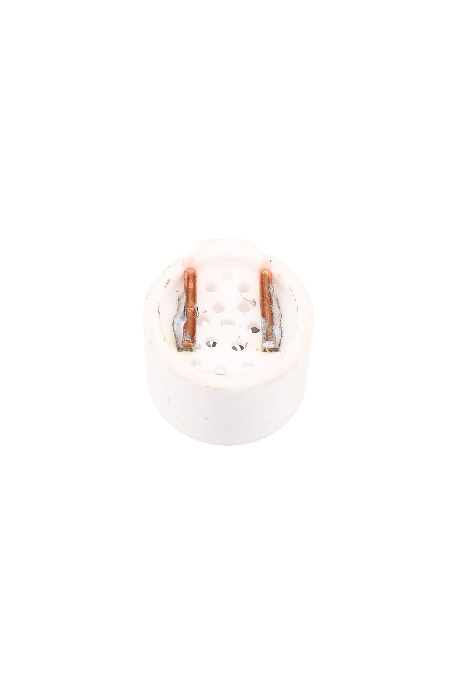 Backside of Solopipe Elektra ceramic bowl showing perforated base and two copper contact tabs on a compact white insert.