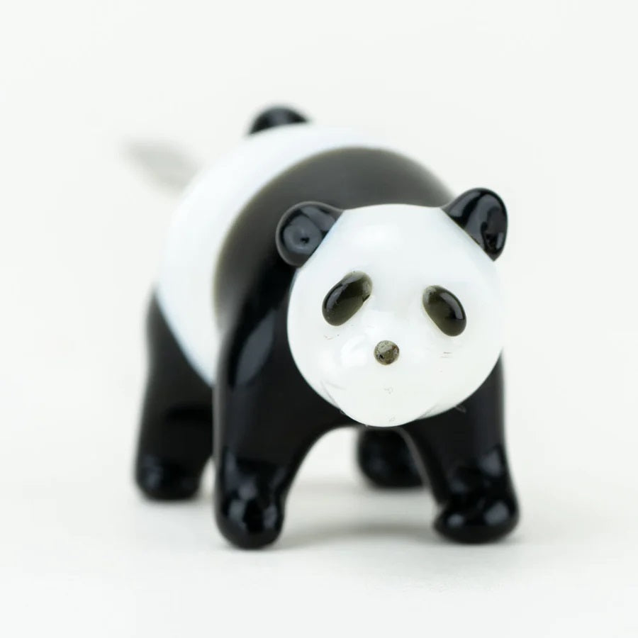 Close front view of sculpted panda face on glass dab tool highlighting eyes, nose, and ears against clean white background.