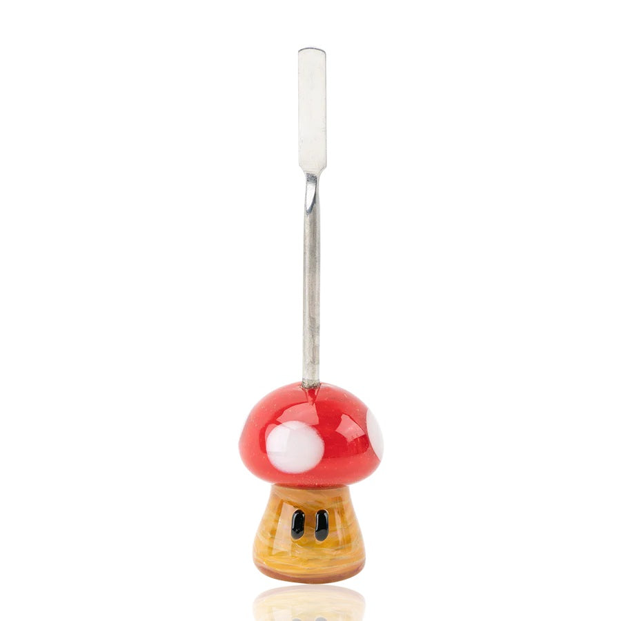 Front view of 5-inch mushroom glass dabber on white backdrop highlighting stainless flat scoop and glossy red cap with white spots.