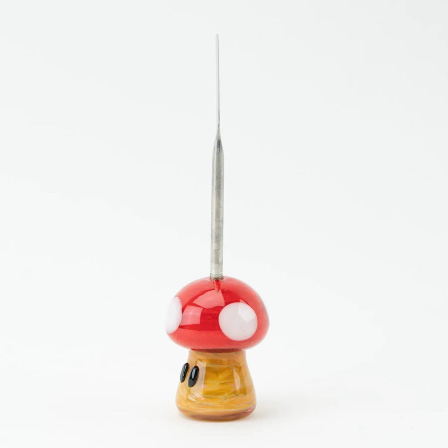 Side profile of mushroom dabber showing tapered stainless scoop and full red-and-yellow glass body, photographed on white background.