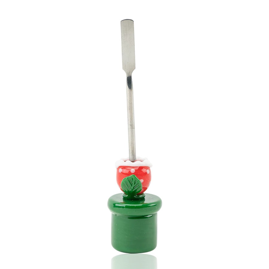 Front view of 5-inch piranha-plant glass dabber on white backdrop showing stainless spatula tip and leaf collar around red spotted head.