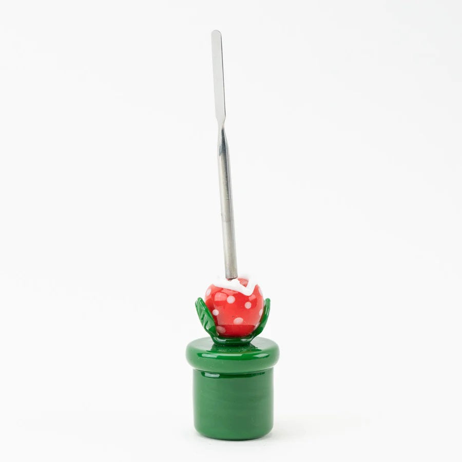 Side profile of piranha-plant dab tool highlighting pipe-style base, leafy arms, and thin stainless scoop against white studio background.