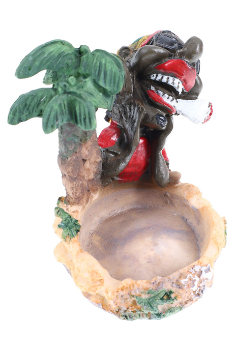 Tropical resin ashtray featuring palm tree and smiling Rasta lounging beside sandy bowl, bright hand-painted details on white.