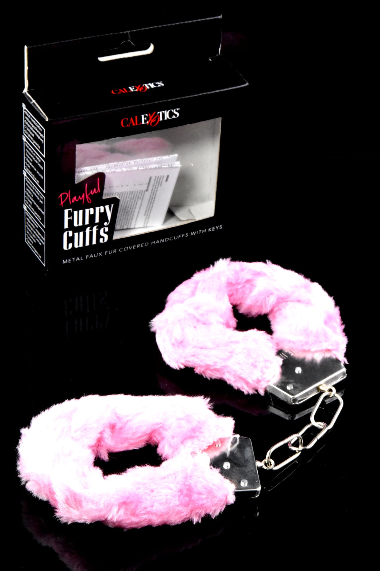 Pink faux-fur metal handcuffs with short chain displayed beside retail box; soft, playful bedroom restraints.