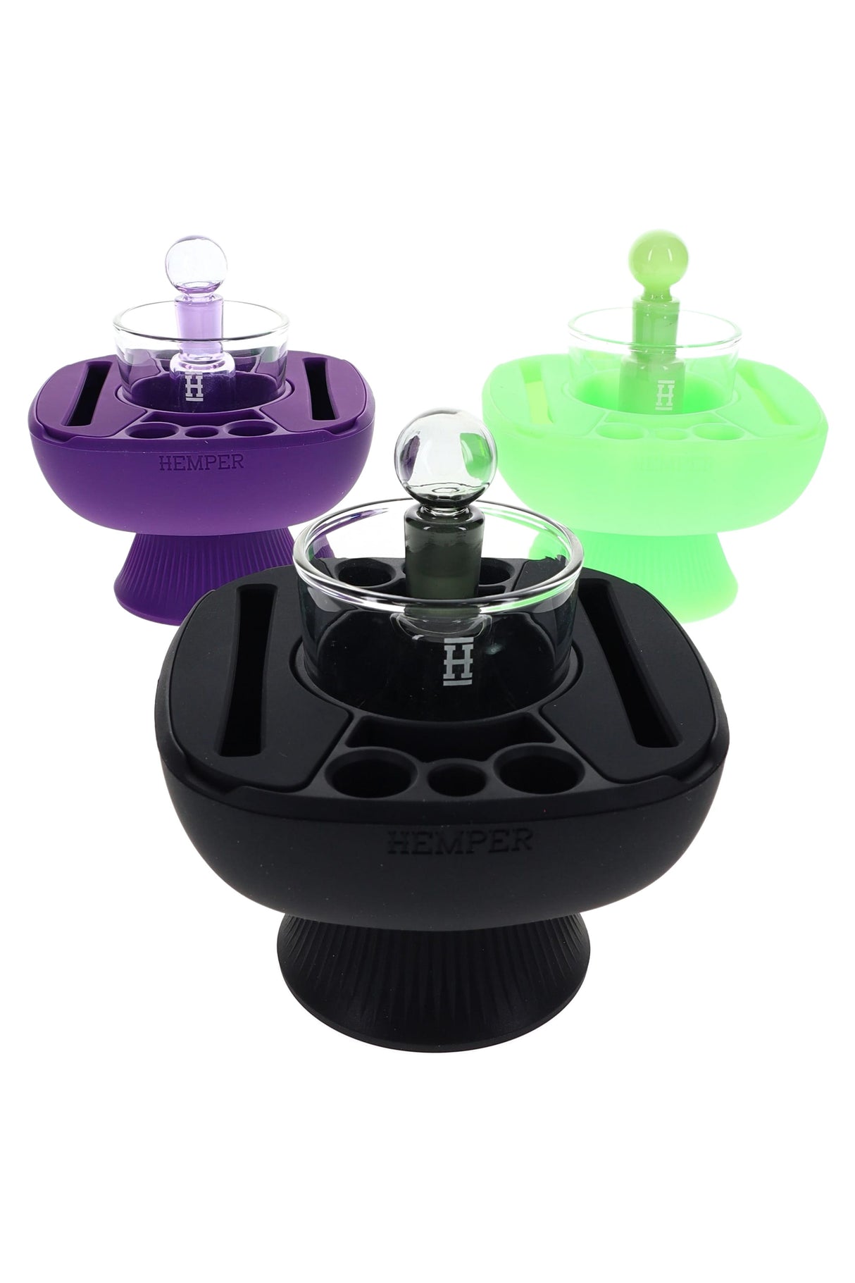 Trio of Hemper IsoPlex silicone concentrate cleaning stations in black, purple and glow green, each with glass ISO cup and matching carb cap.