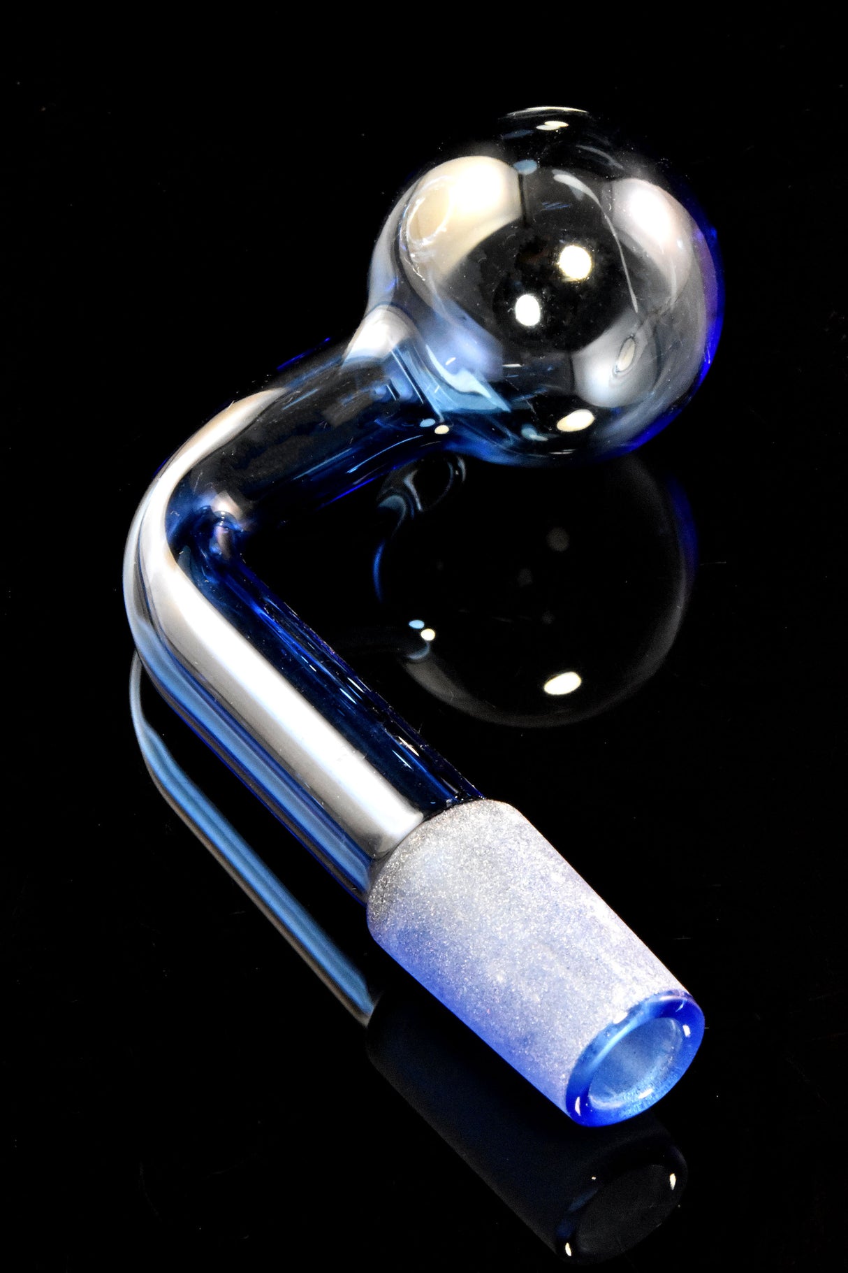 Blue L-shaped 14.5 mm male colored glass oil burner with clear globe and frosted joint on glossy black surface.
