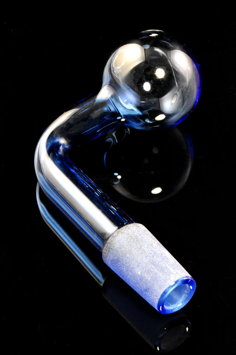 Blue L-shaped 14.5 mm male colored glass oil burner with clear globe and frosted joint on glossy black surface.