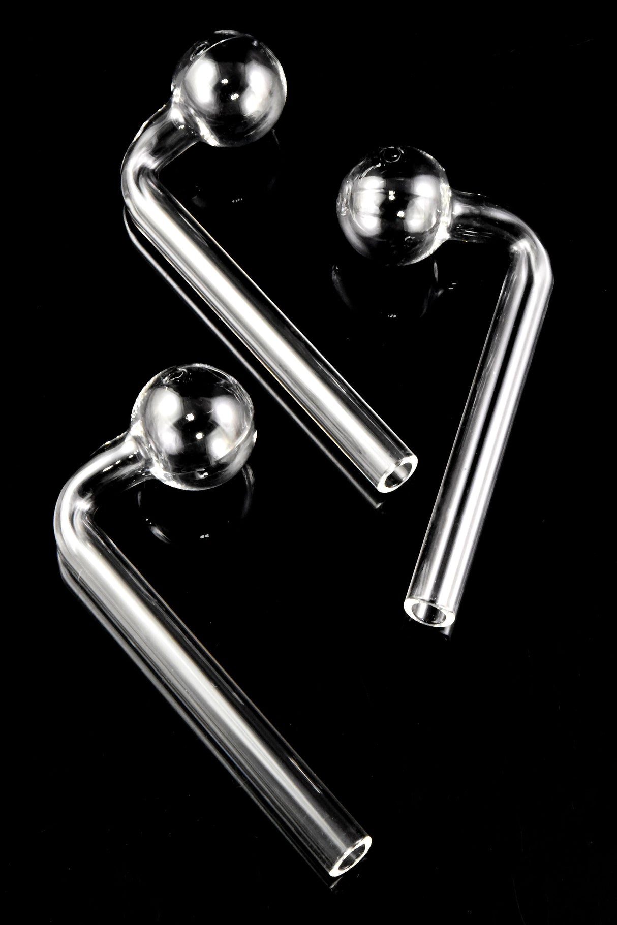 Three clear L-shaped glass oil burners on black background, thick glass with round bowls and open tips, compact 4½″ size for everyday use.