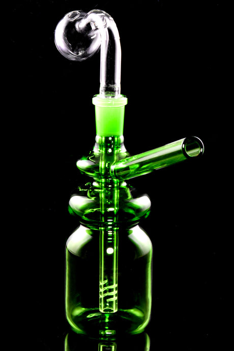 Green bottle-shaped mini oil burner rig with donut neck accents and angled straw mouthpiece, black background.